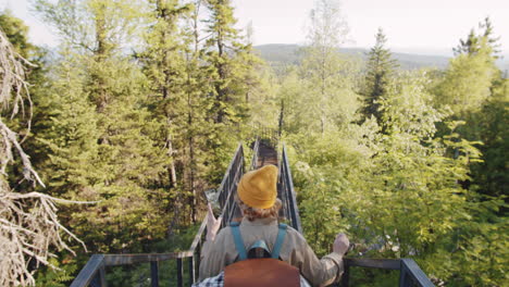 woman hiking on a mountain bridge