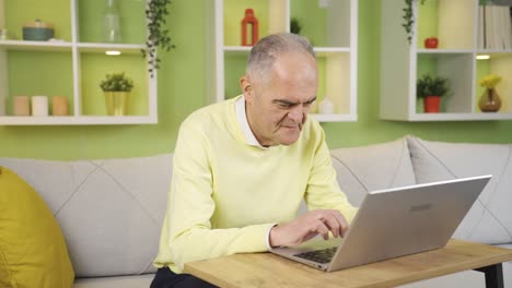 Elderly-retired-man-using-computer-to-transfer-money-or-make-financial-payment-online.