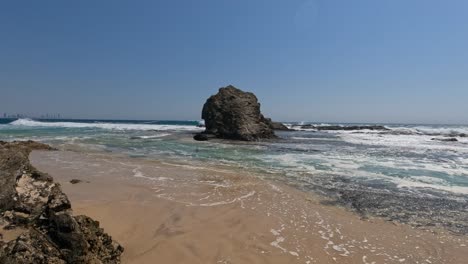 currumbin rock - currumbin beach rock formation and sea waves in qld, australia