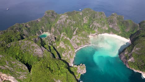 aerial 4k drone video of phi phi leh with maya bay and pileh lagoon, krabi province, thailand. aerial top view of amazing tropical island with turquoise water and white beach, famous destination.