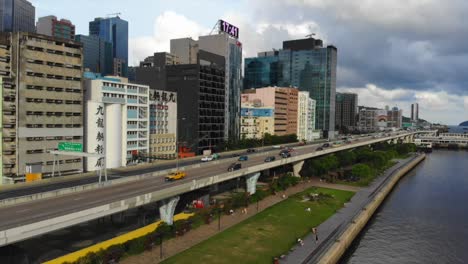 Drone-shot-over-park-and-highway-in-Kwun-Tong,-Hong-Kong-