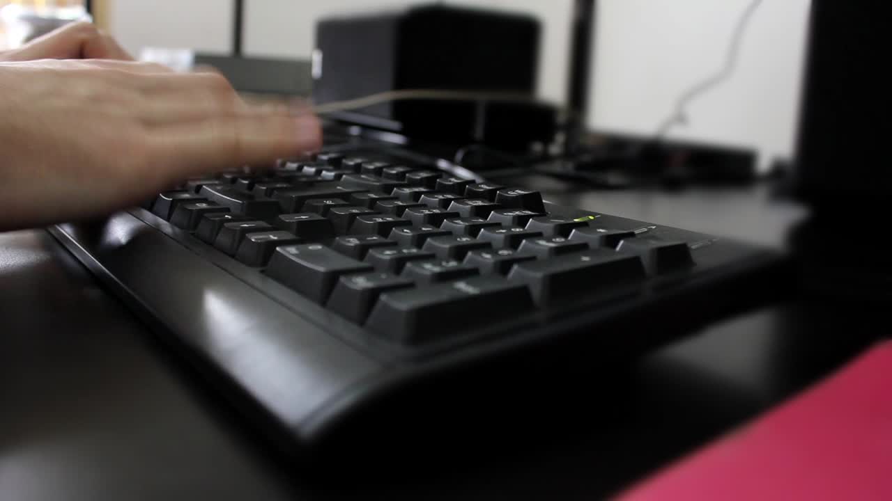Close-up of a Hand Typing on a Computer Keyboard