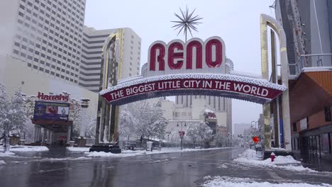 the reno arch greets visitors to reno nevada during a winter snowstorm