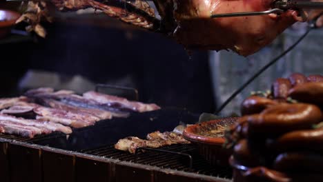 street food. pork being cooked over a hot charcoal fire