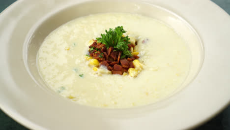 corn soup with crispy bacon on plate