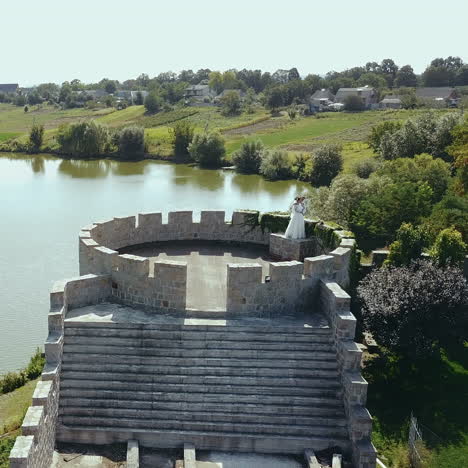 newlyweds in the old castle. aerial view square video