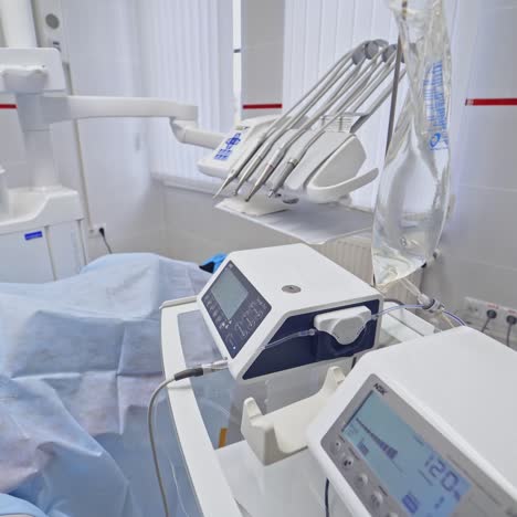 modern equipment in a dental office. dentist together with his assistant treat patient's teeth. stomatologist in blue medical uniform at work.