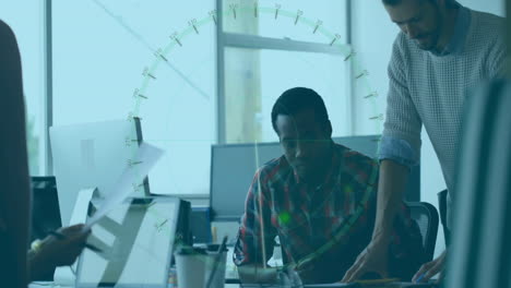 diverse team collaborating at office desk with digital data overlay animation
