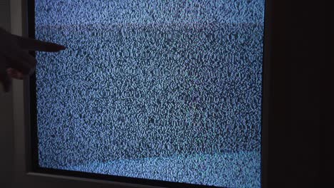 female hand touching an old tv screen with ripples