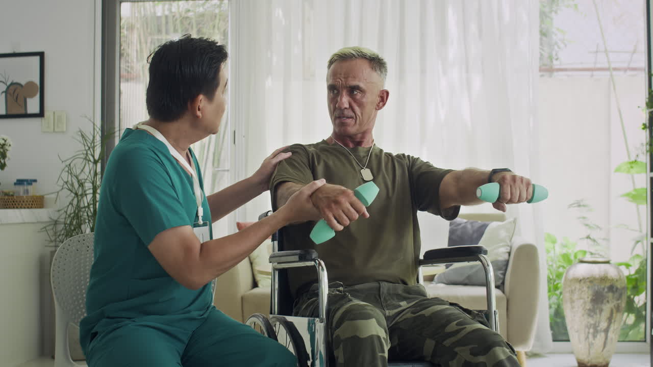 Rehabilitation Specialist Working with Wounded Soldier at Home