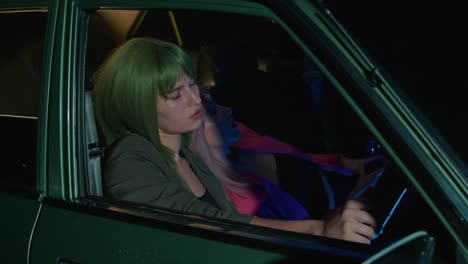 two women in a car at night