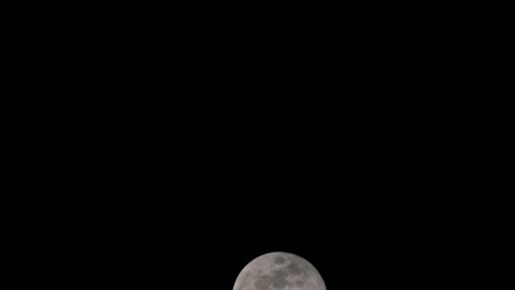 moon slowly rising from the bottom to go out of the frame to the top in a time-lapse, lunar eclipse in thailand last november 8, 2022