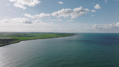 seahouses, uk coastline with bamburgh castle off in the distance in 4k