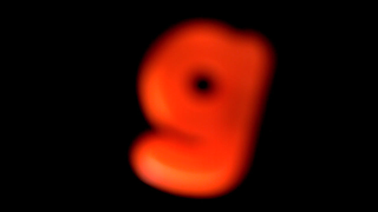 The letter g coming into focus on black background