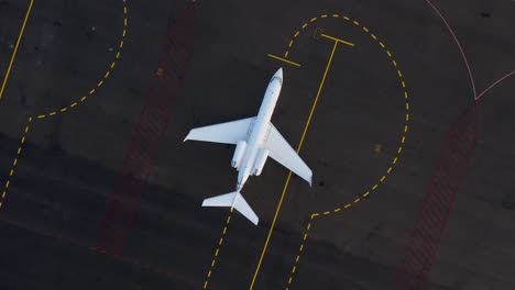 gulfstream iv-sp business private jet parked on airport tarmac with lines, top down