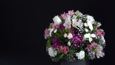 white carnation and roses spinnings in black background and slider