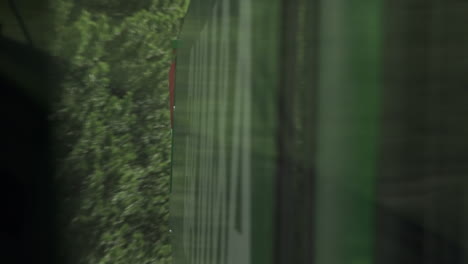 Mirror-reflection-of-train-moving-across-countryside