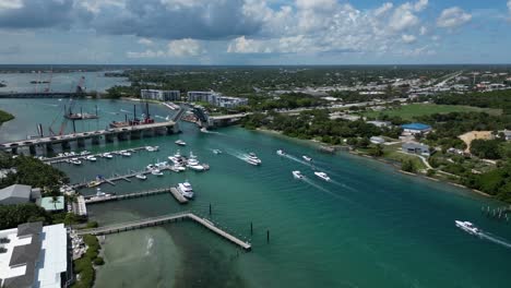 Aerial-Footage-of-the-Indian-River-with-Speed-Boats-Heading-Toward-a-Bascule-Bridge-in-Florida