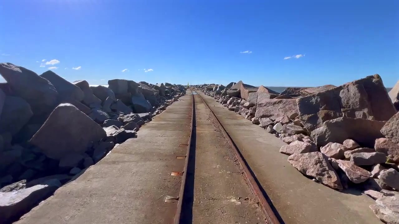 Forward push along a railway track on the breakwater in Rio Grande, Brazil.