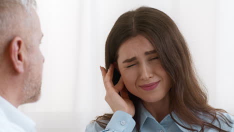 doctor consults patient suffering from headache