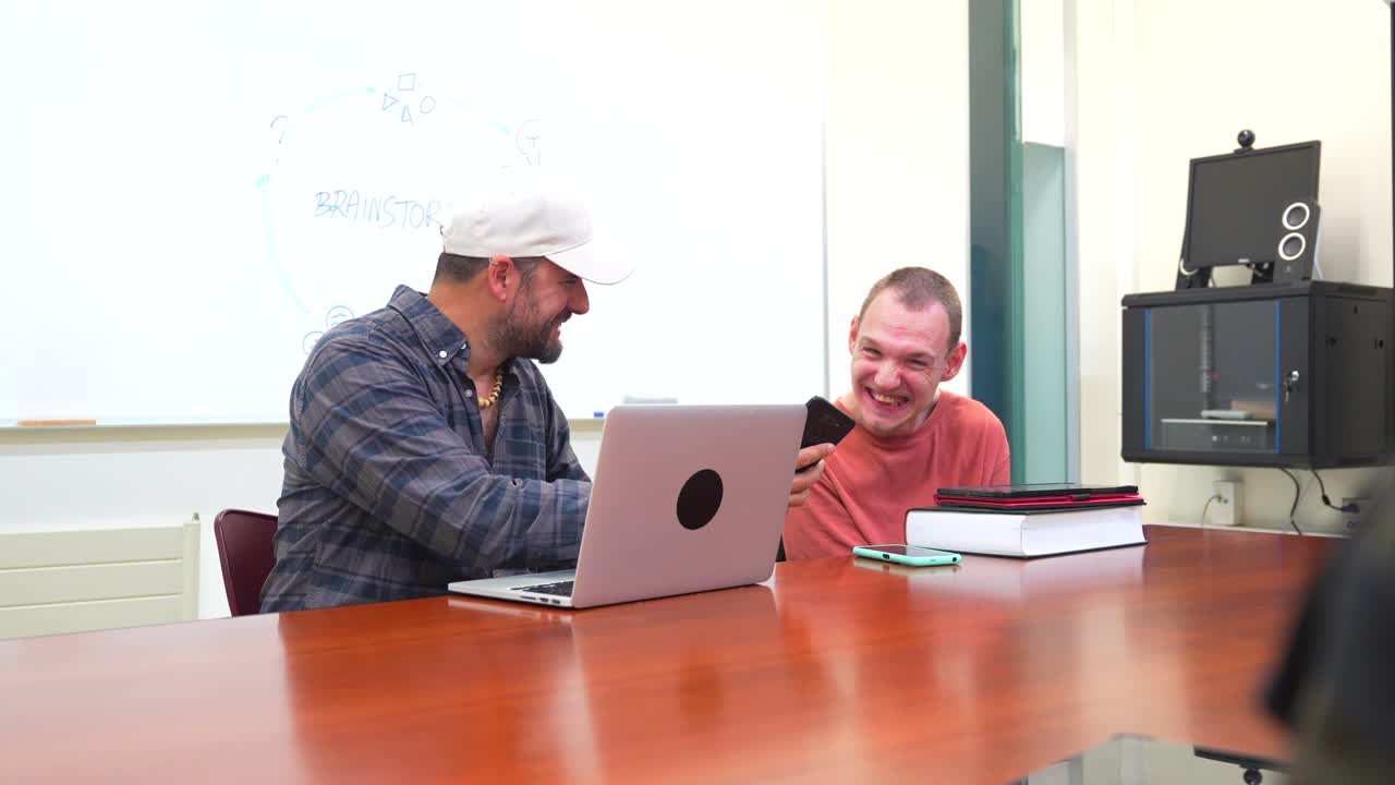 Two men collaborating on a project in an office setting