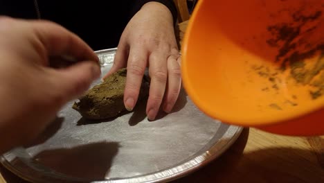 forming organic moringa and ginger herbal remedy mixture on silver tray