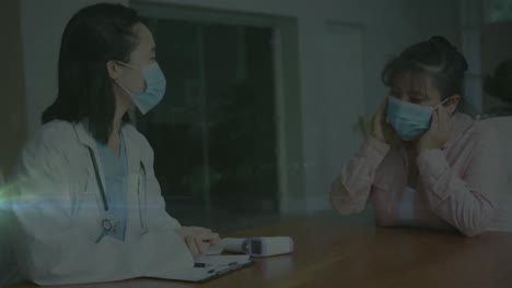 Animation-of-light-spots-over-asian-female-doctor-talking-with-patient