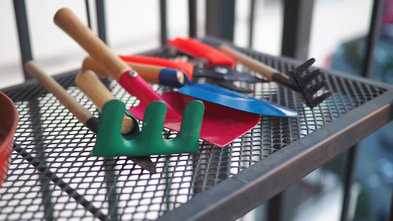 Gardening tools on a metal shelf