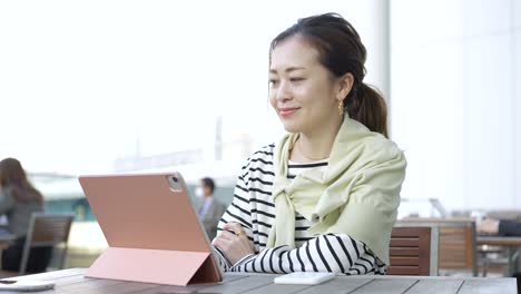 female using a tablet pc outdoors