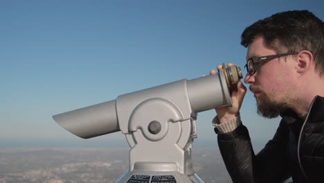 man using a telescope