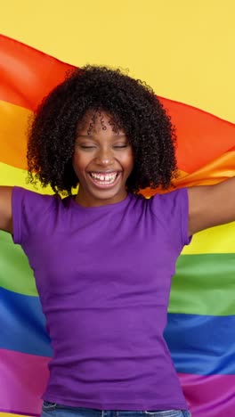 happy woman celebrating pride with rainbow flag
