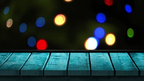 Animation-of-christmas-flickering-lights-with-blue-wooden-surface