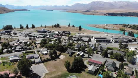 aerial view of small town on turquoise lake tekapo lakefront, main street and observatory