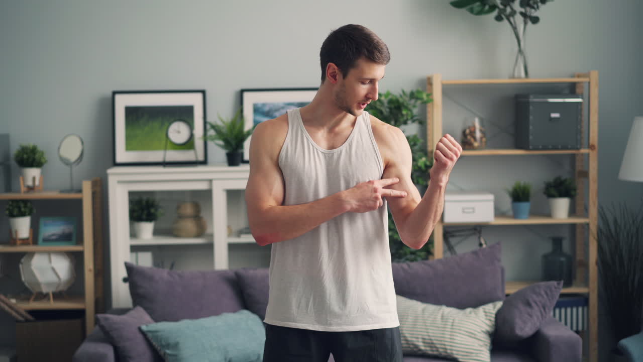 Man giving a fitness presentation in his living room