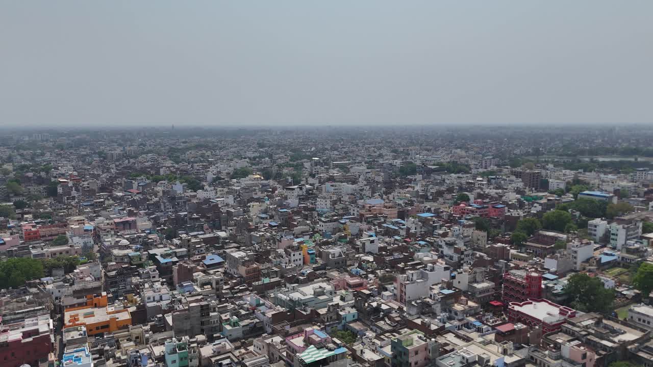 High-angle view capturing the tightly packed housing and bustling streets of Varanasi, where every corner tells a story.