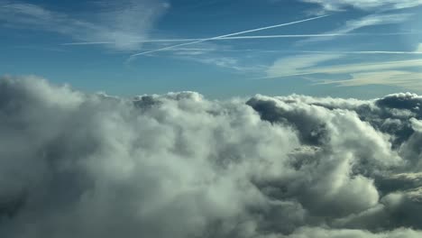 Unique-pilot-POV-shot-from-an-airplane-cockpit-in-a-real-time-flight-through-a-turbulent-sky-plenty-of-clouds-at-the-golden-minute