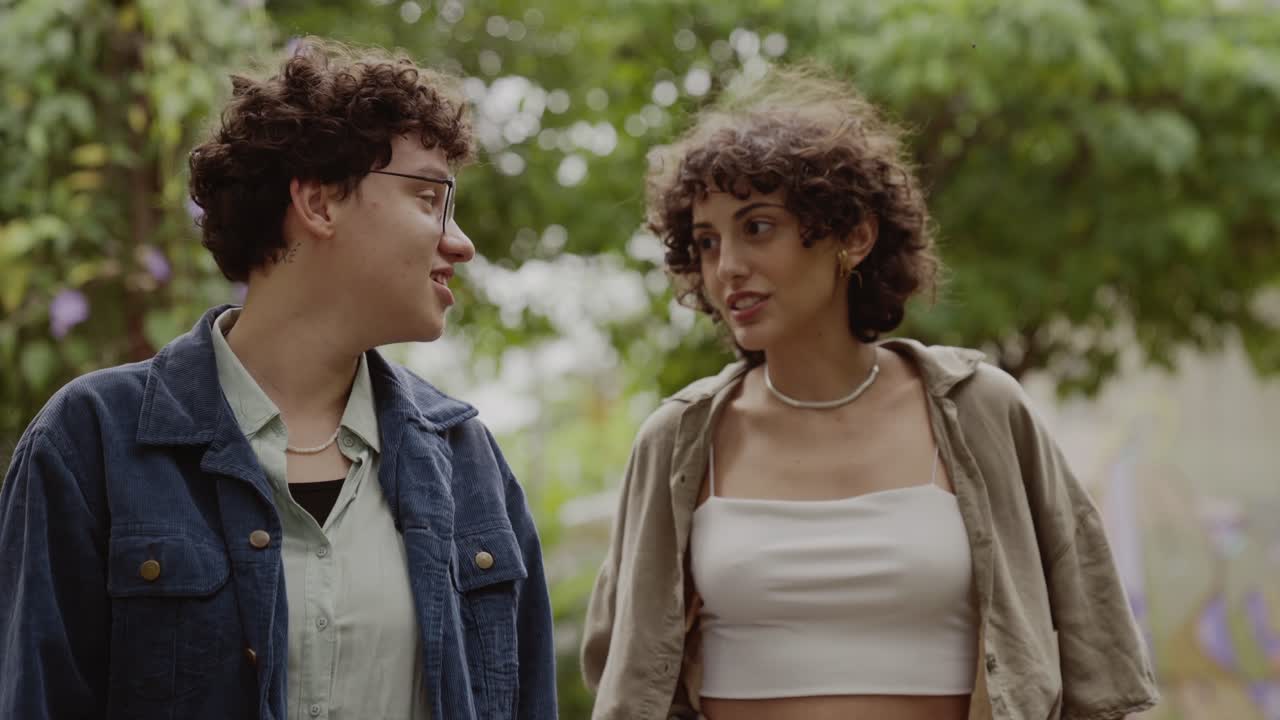 Two young women talking in a park