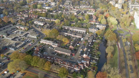 Aerial-of-a-suburban-neighborhood-with-solar-panels-on-several-rooftops---drone-flying-backwards