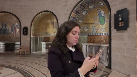 modern pilgrim photographing sacred christian site. slow motion.