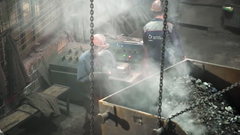 industrial workers loading coal into containers