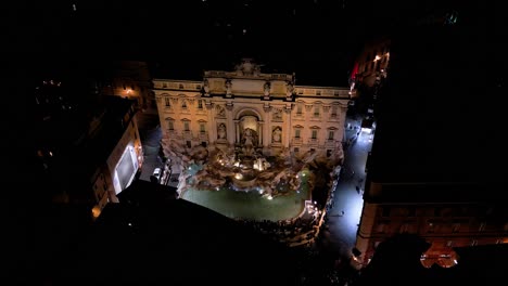 cinematic establishing drone shot above trevi fountain at night