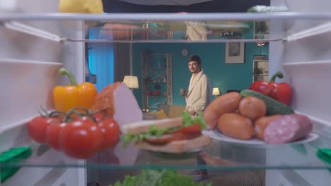 open fridge with food and person