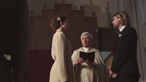 bride and groom pronouncing wedding vows in church