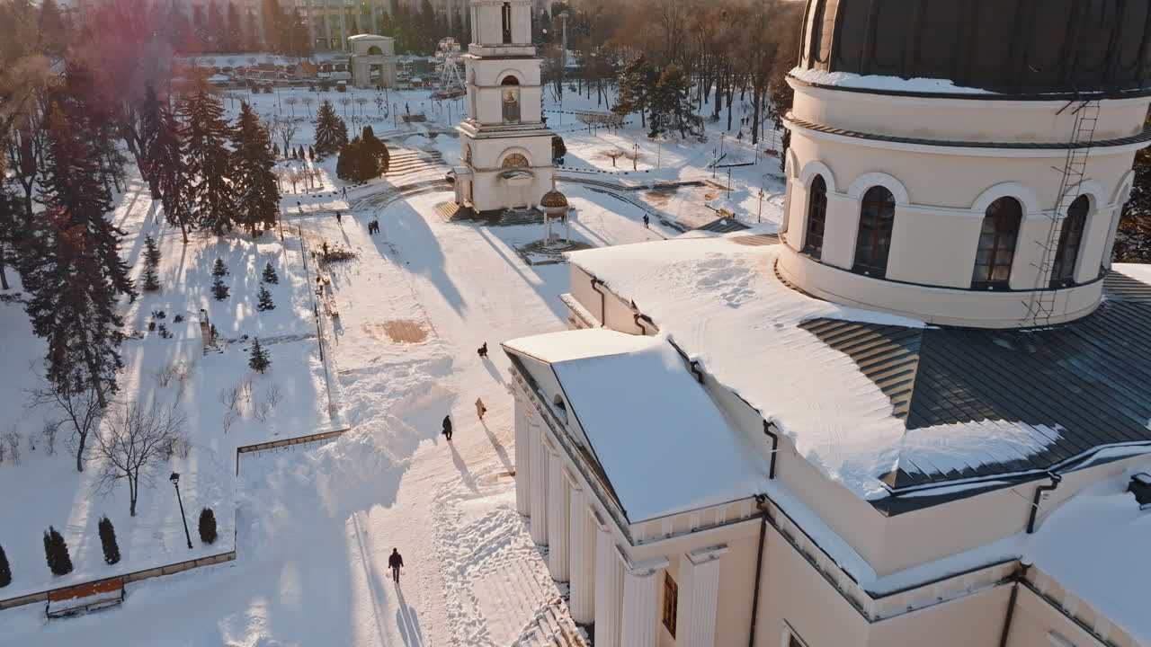 Aerial drone view of the Bell tower and the Metropolitan Cathedral of Christ's Nativity. City center covered in snow at sunset in Chisinau, Moldova