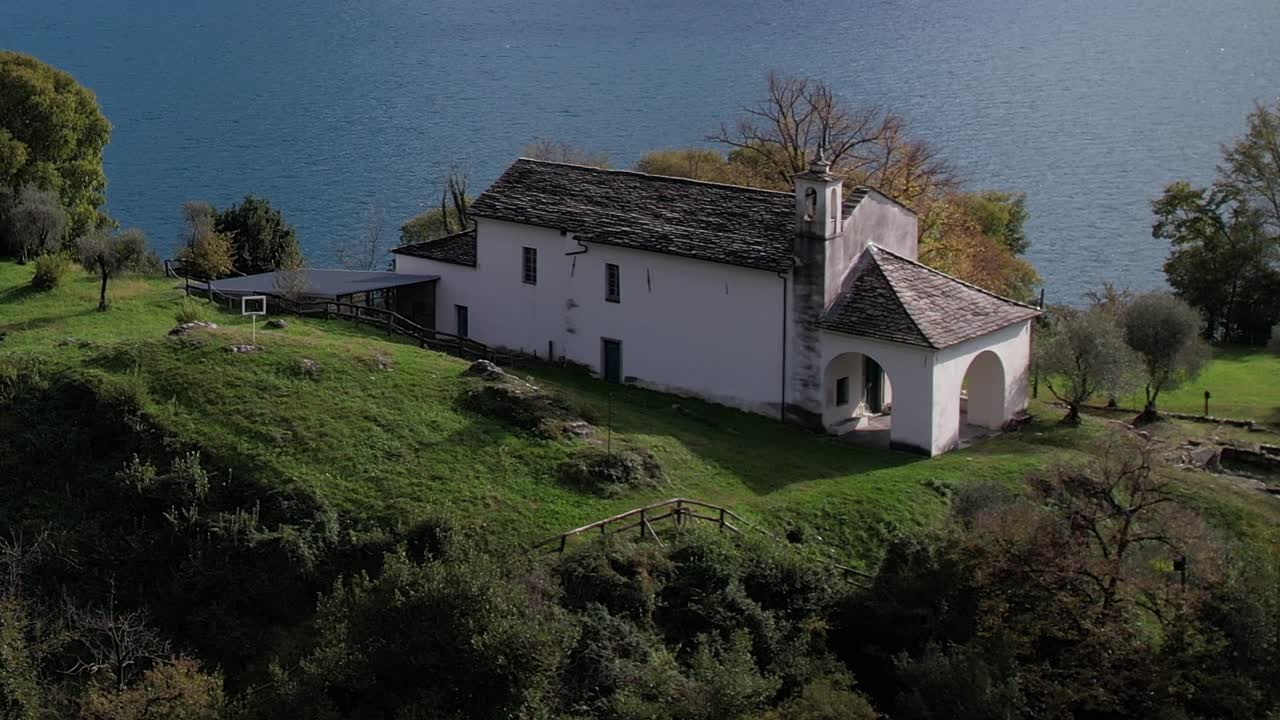 Stunning aerial view of a historic building near water in the Italian Alps