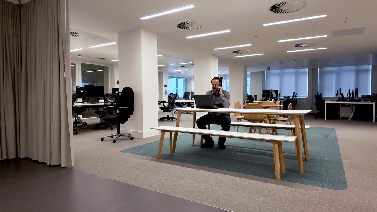 Remote work communication and work-life balance showing a South Asian man working alone on his mobile phone