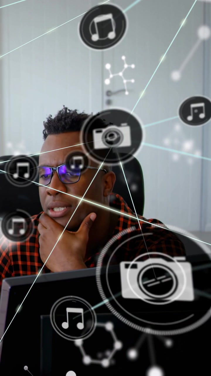 Vertical video: Overlay appearing, man leaning, touching chin, checking camera music icons for tech