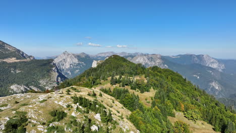 Flight-over-grass-covered-mountain-plains