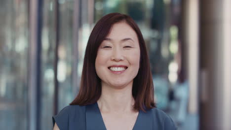 portrait of japanese businesswoman outside corporate office building