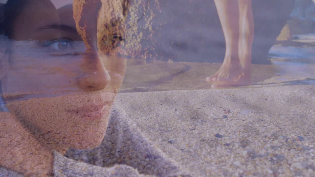 Overlaying woman's face with sandy beach and walking feet, creating serene animation